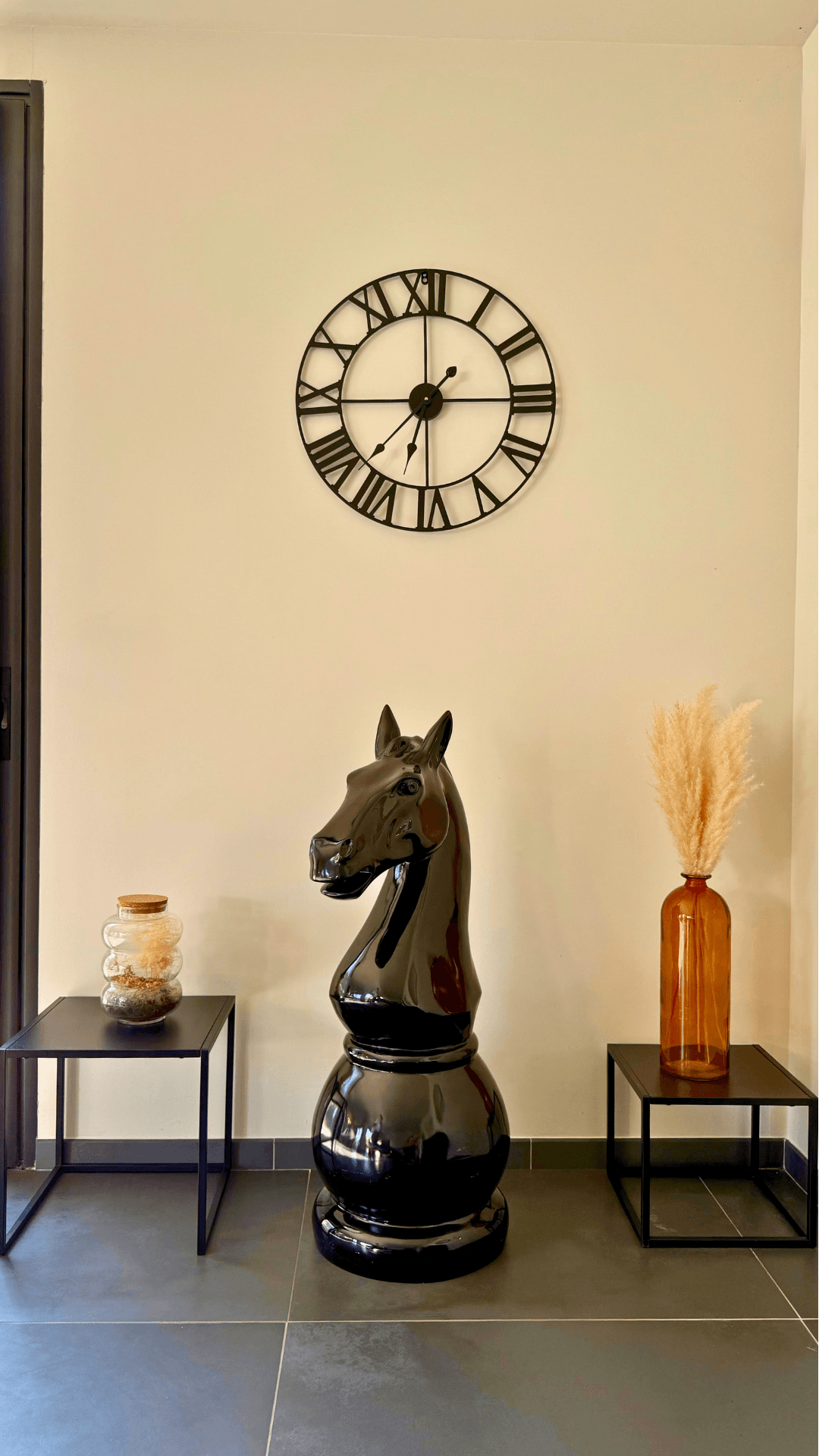 Statue Échecs - GRANDIOSE en forme de cavalier noir brillant de 1m40 en résine, posée dans un intérieur moderne avec déco minimaliste. Sculpture design idéale pour salon ou hall d’entrée, résistante et élégante.